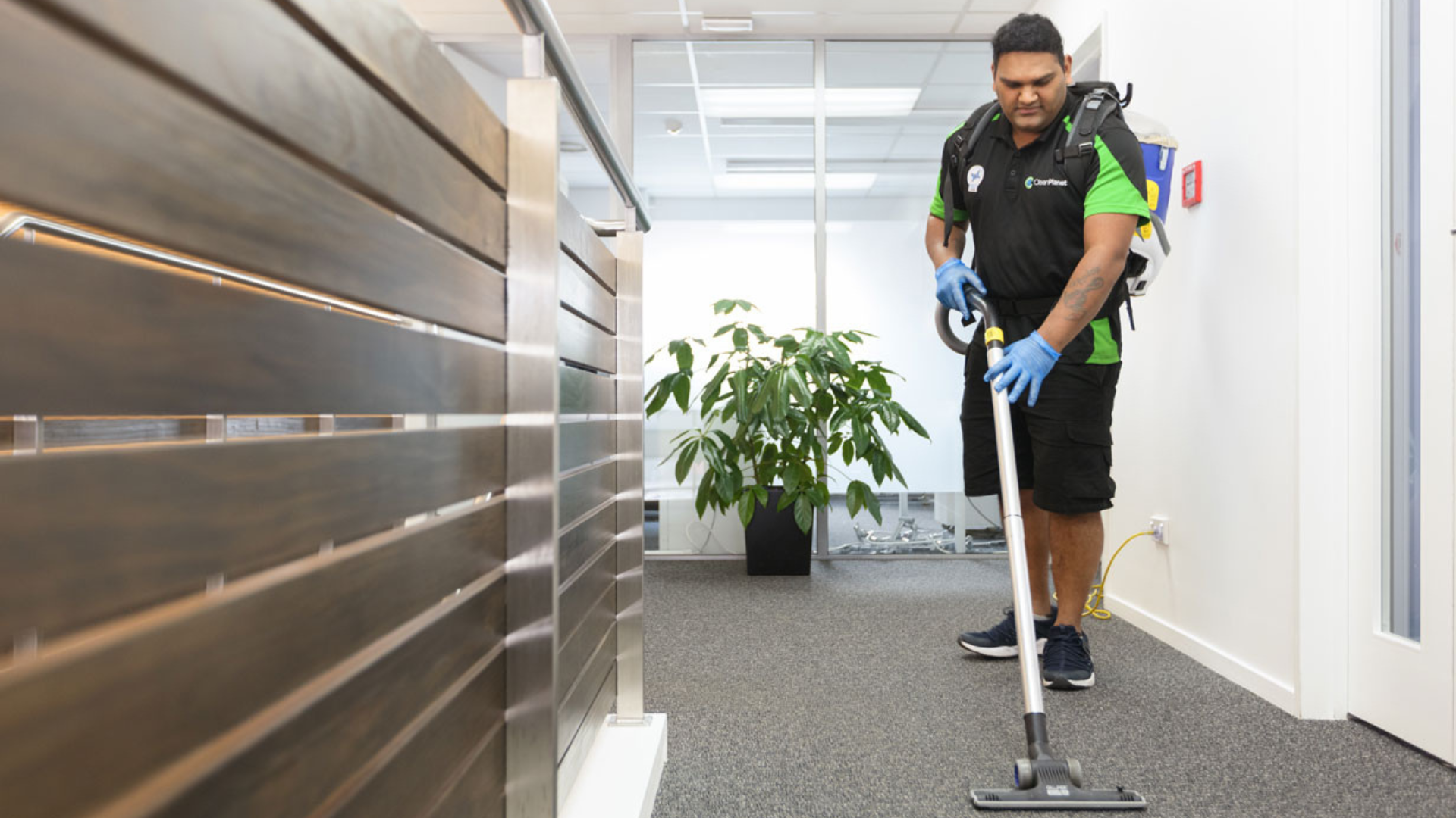 Clean Planet cleaner vacuuming office with asthma-friendly HEPA filter